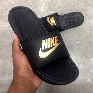 black and gold nike flip flops